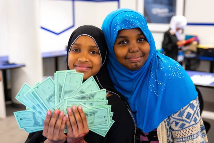 Two girls learning about finances at JA North