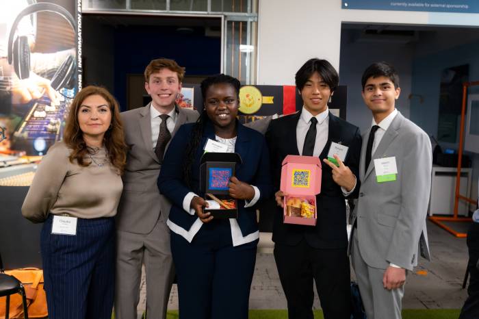 Clutra, a competing student company, poses with their advisor during the COY 25 expo