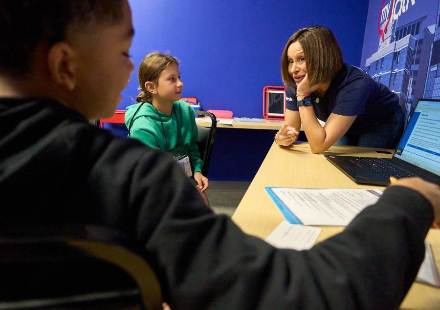 A U.S. Bank team member volunteers with fifth graders in JA BizTown